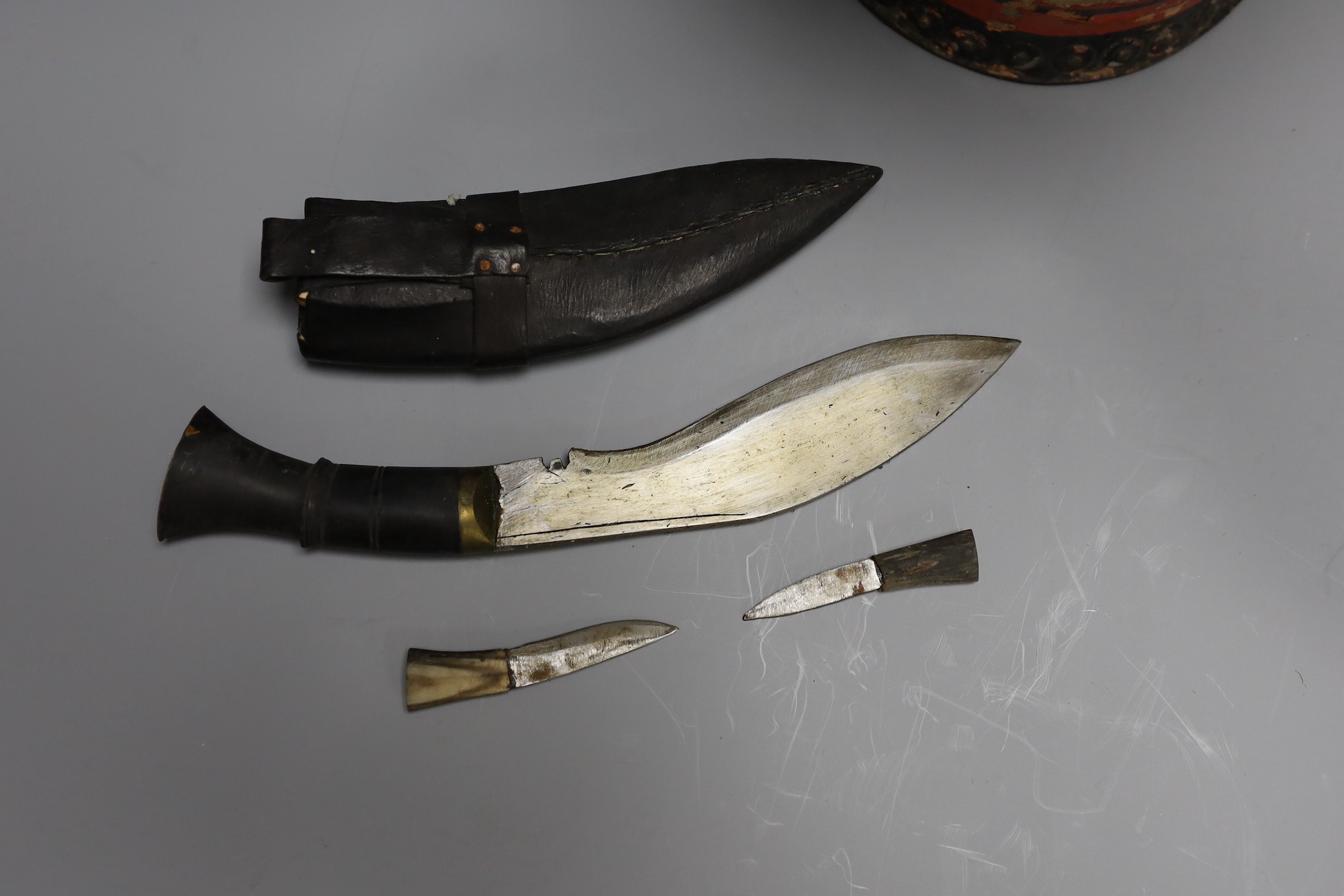 A 19th century iron bound painted leather fire bucket together with a small kukri knife